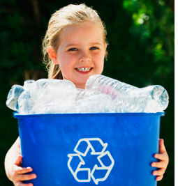 Little girl with recycling bin