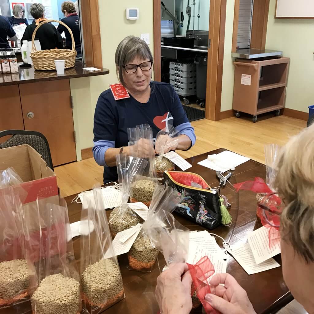 Assistance League Bellingham volunteers packaging soup mixes with a pretty bow!
